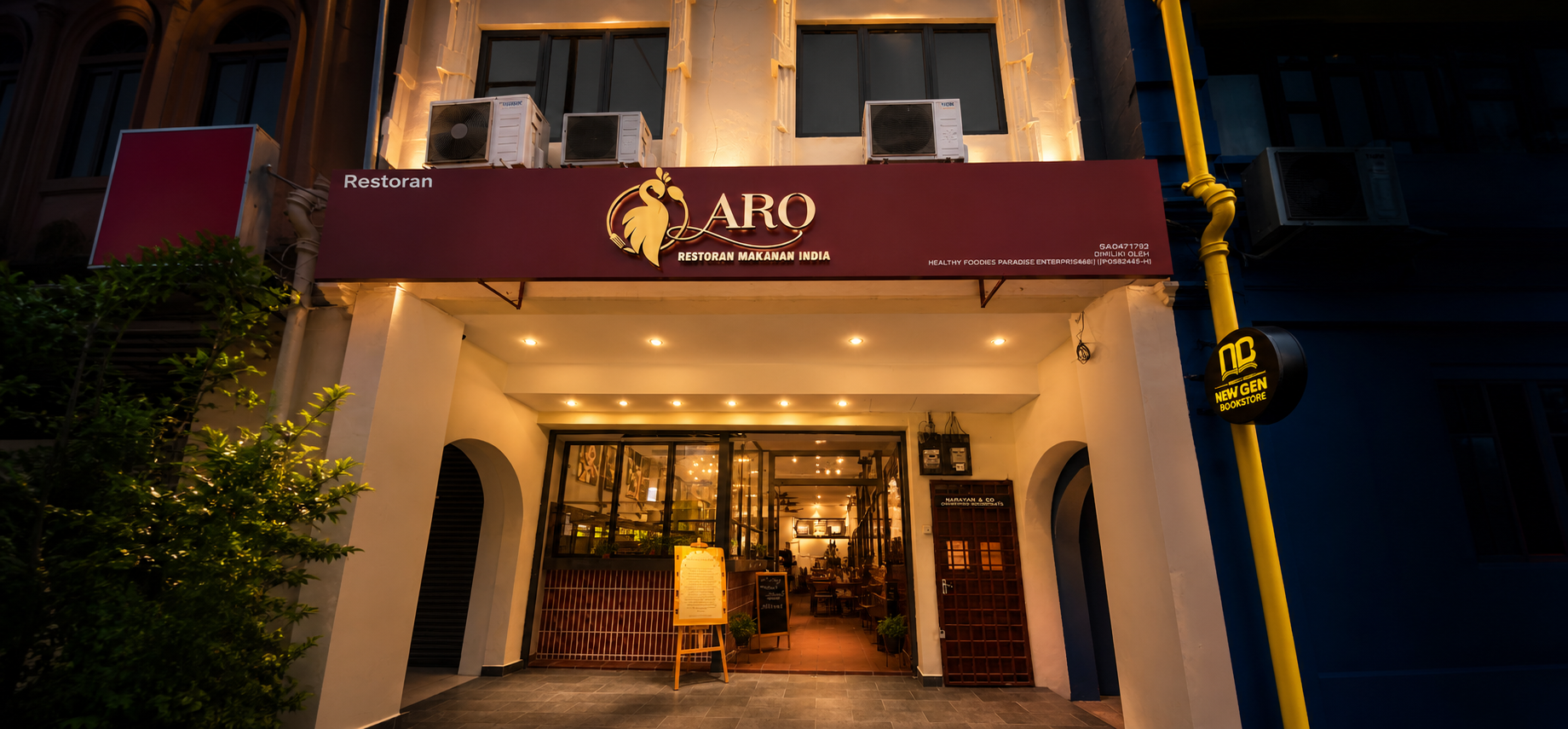 Street-level facade of Aro Restaurant with its burgundy ARO sign above the entrance.